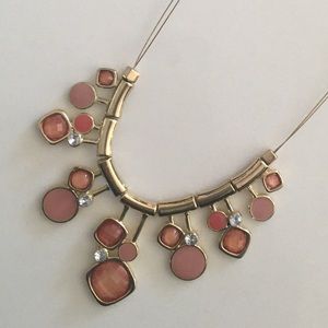Gold toned and pink jewel statement necklace.